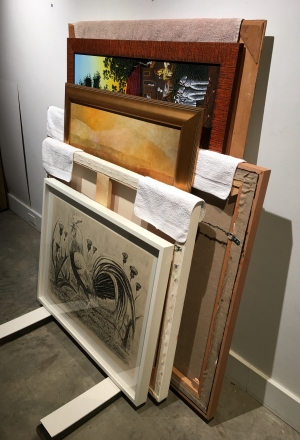 When separators are not available, artworks can be stacked front-to-front and back-to-back making sure that each artwork added has at least two points of contact with the artwork in front of it.  Where two artworks touch in the face -to-face configuration, washcloths can be used to pad the frames at the points where the frames touch.